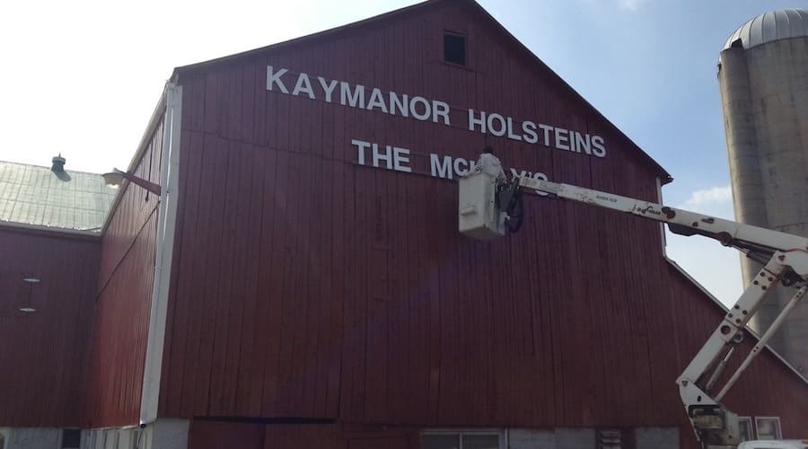 Repainting name on barn